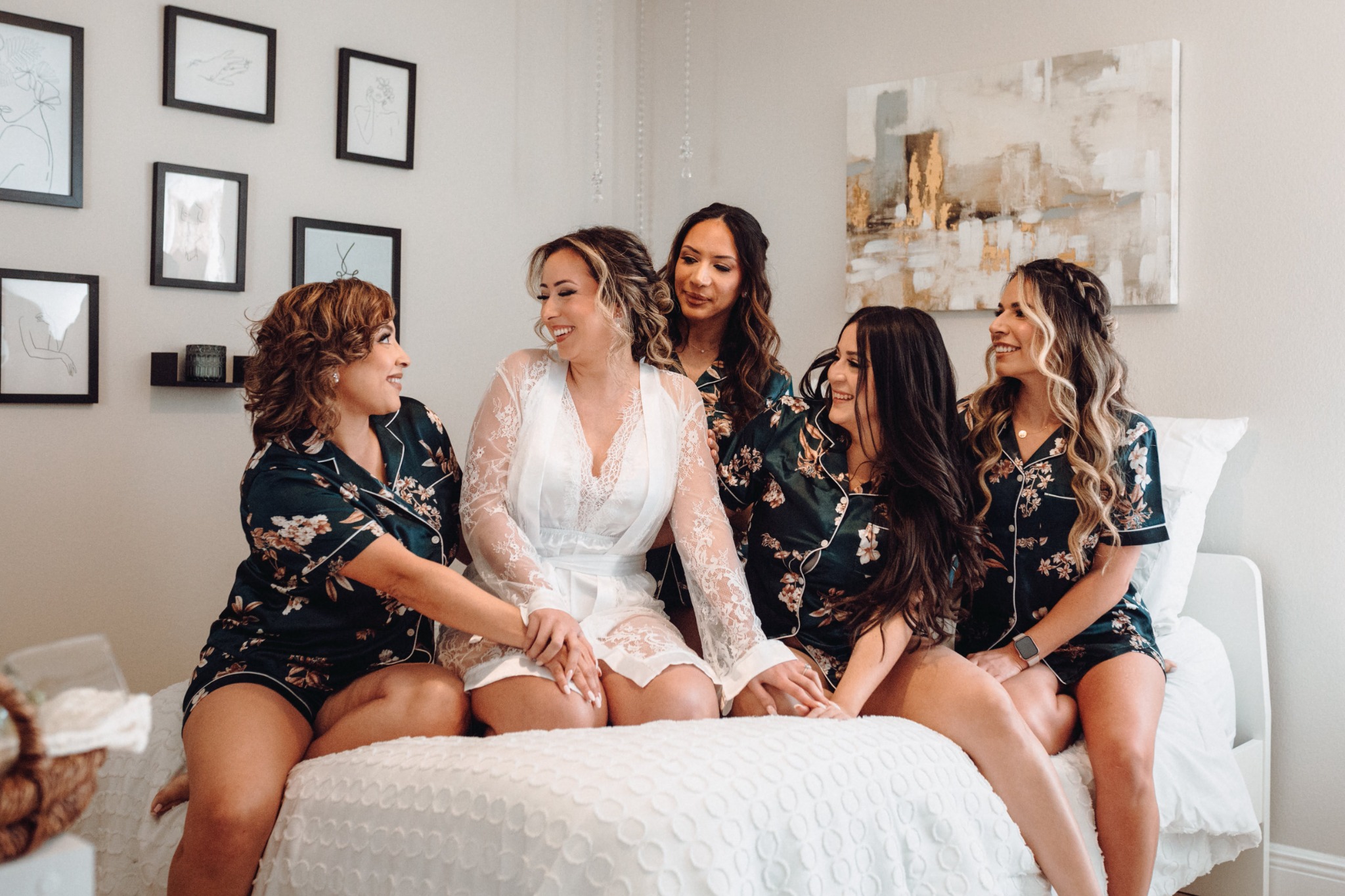 Bride laughing with her wedding party while getting ready